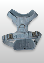 Blue dog harness on a light gray background