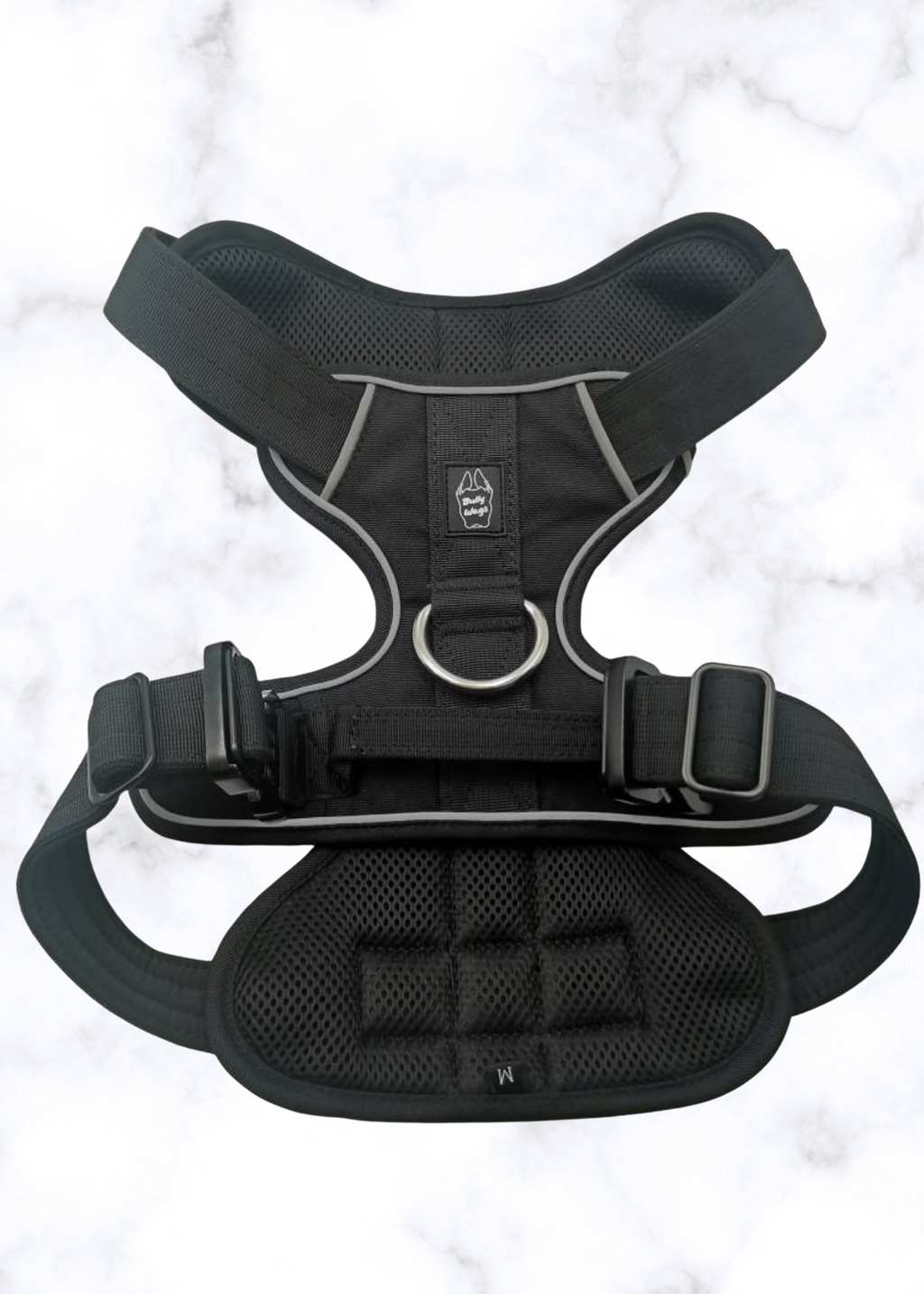 Black dog harness on a light gray background