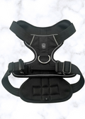 Black dog harness on a light gray background
