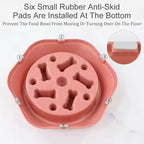 Pink pet food bowl with anti-skid pads on a white background