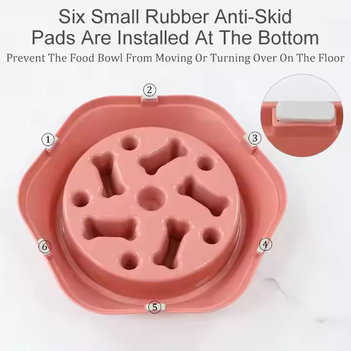 Pink pet food bowl with anti-skid pads on a white background
