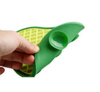 Green lick mat held by a hand on a white background