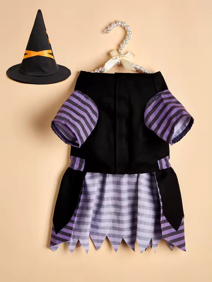 Pet Halloween costume with black top, striped skirt, and witch hat on a beige background