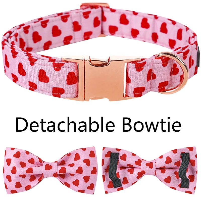 Dog collar with red heart pattern and detachable bowties on a white background