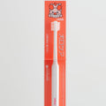 Dog toothbrush with packaging featuring a cartoon dog on a light gray background