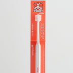Dog toothbrush with packaging featuring a cartoon dog on a light gray background