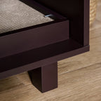 Close-up of a wooden cat litter cabinet with a scratch pad on a wooden floor.