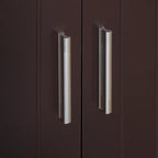 Close-up of two metallic cabinet handles on a dark brown door.