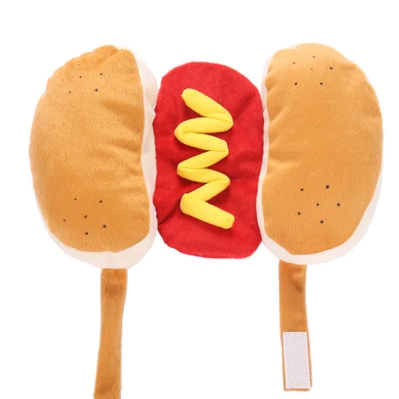 Plush hot dog pet halloween costume, red body, and yellow mustard on a white background