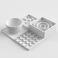 A white slow feeder set on a light gray background, featuring a bowl, a tray with small raised spheres, a spiral insert, and a hexagonal grid mat.