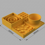 A yellow slow feeder set on a light gray background, featuring a bowl, a tray with small raised spheres, a spiral insert, and a hexagonal grid mat.