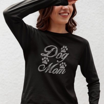 Person wearing a black long-sleeve shirt with 'Dog Mom' text and paw prints on a light gray background