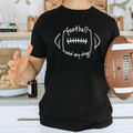 Person wearing a black t-shirt with 'football and my dog' design, holding a Wilson football in a kitchen.