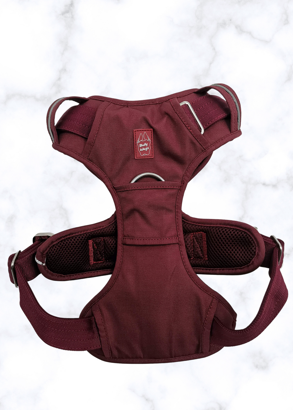 Burgundy dog harness with brand logo on a light gray background