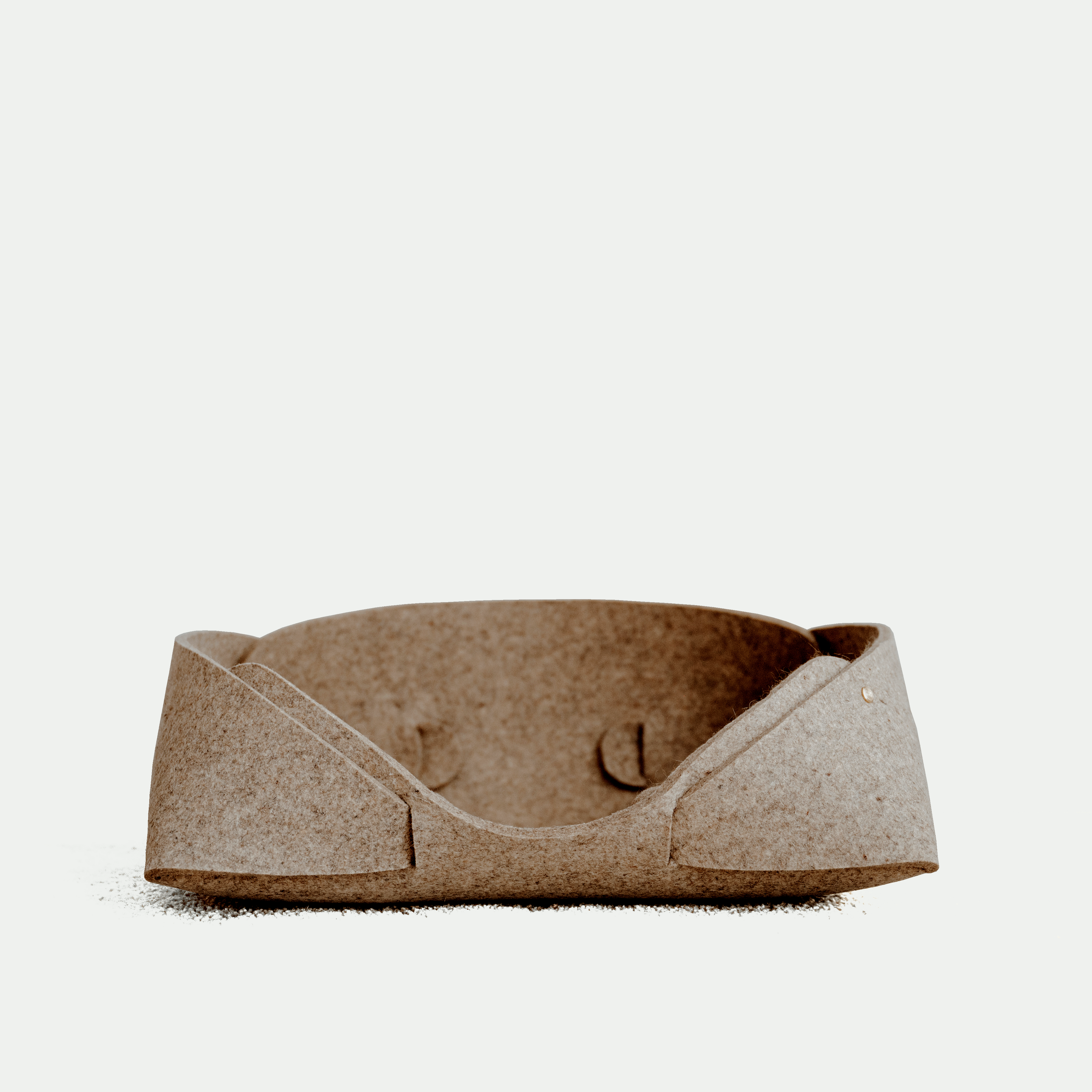 Brown felt cat bed on a white background