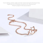 Rose gold cat-shaped necklace on a white background