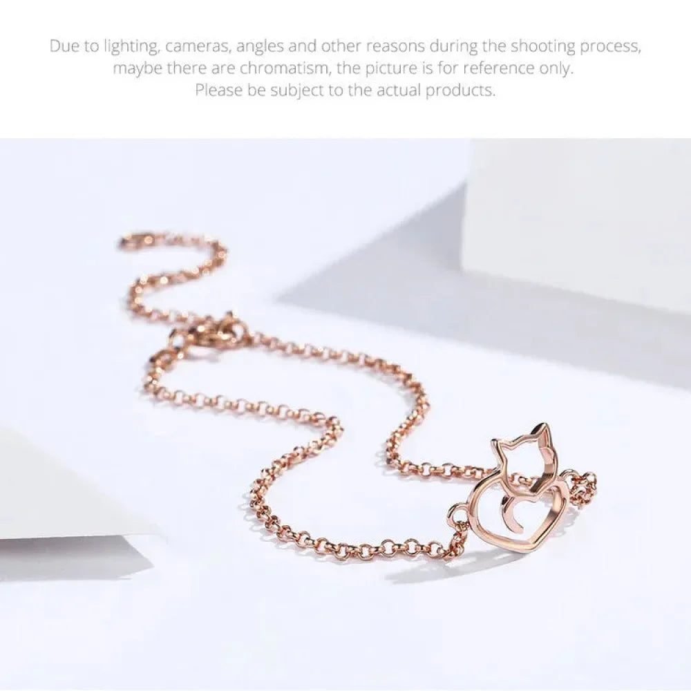 Rose gold cat-shaped necklace on a white background