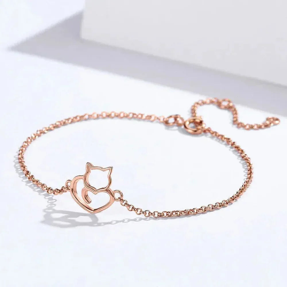 Rose gold bracelet with cat design on a white background