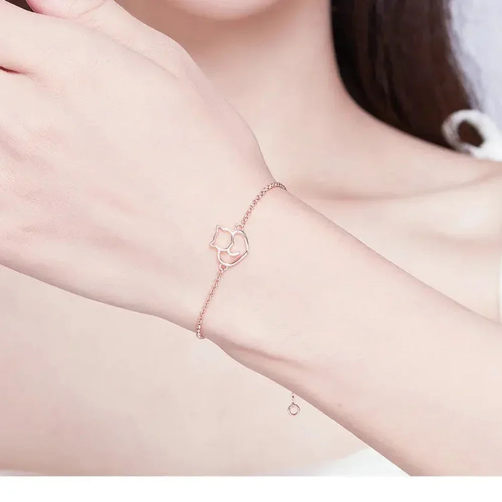 Rose gold bracelet on a wrist with a soft pink background