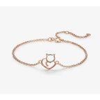 Rose gold bracelet with a cat and heart design on a white background