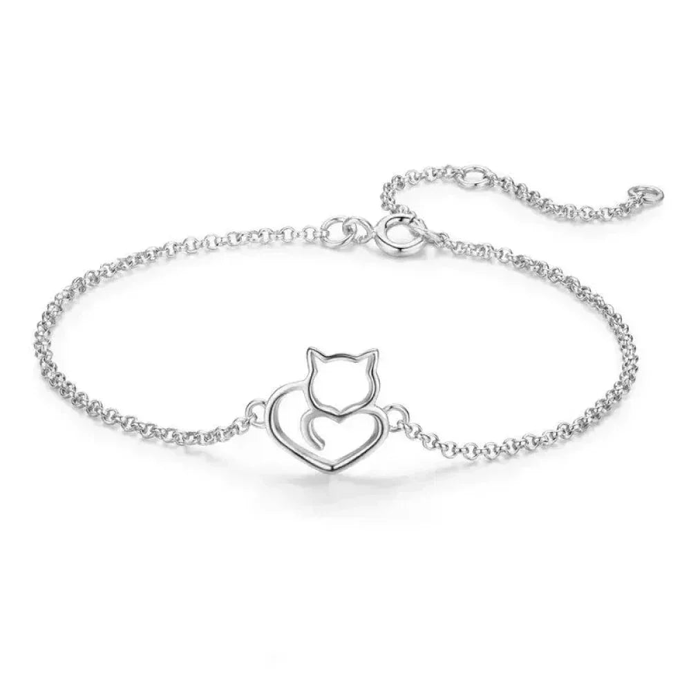 Silver bracelet with cat and heart design on a white background