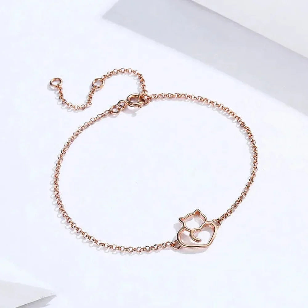 Rose gold bracelet with a cat-shaped clasp on a white background