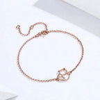 Rose gold bracelet with a cat-shaped clasp on a white background