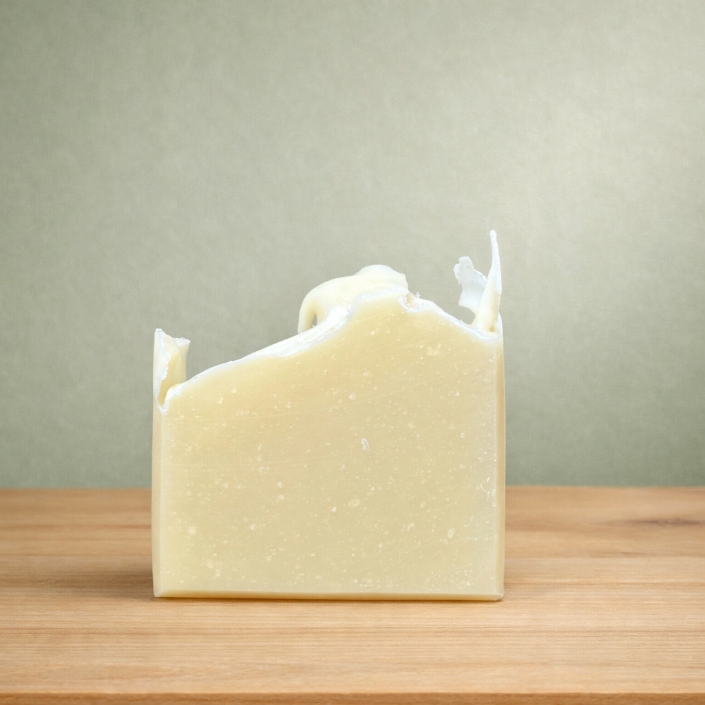 Bar of soap on a wooden surface with a neutral background
