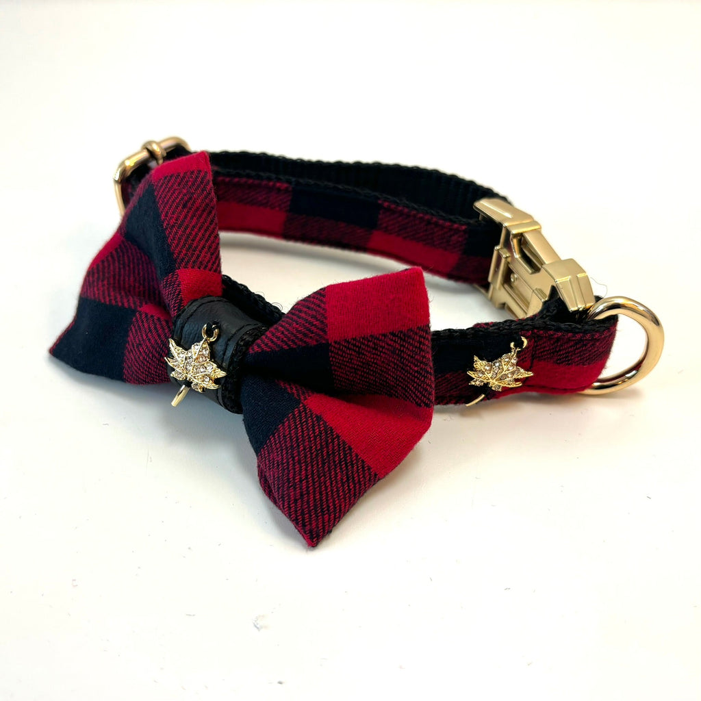 Red and black plaid dog collar with a bow tie and gold hardware on a white background