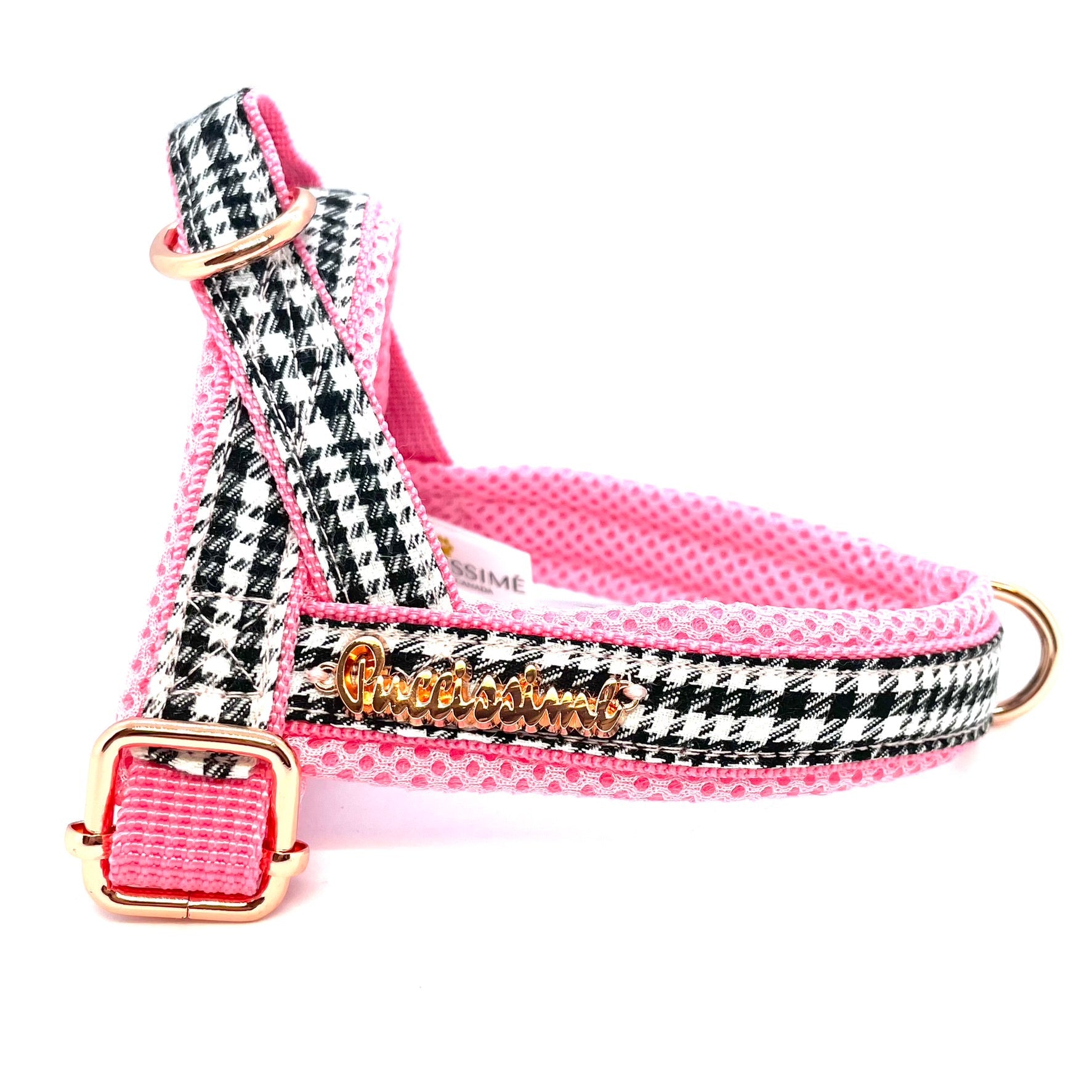 Dog harness with pink and black houndstooth pattern on a white background
