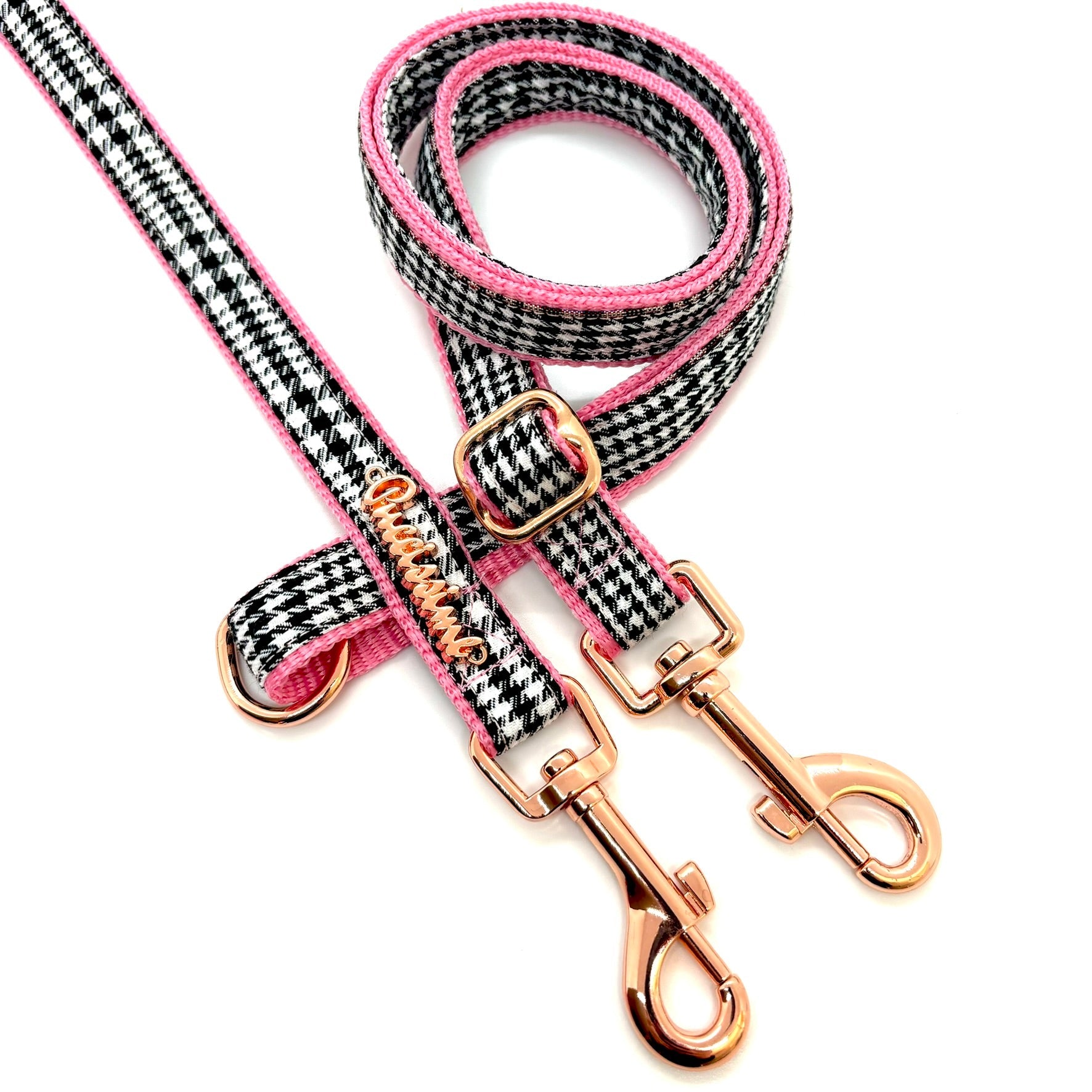 Dog leash with pink and black pattern and rose gold hardware on a white background