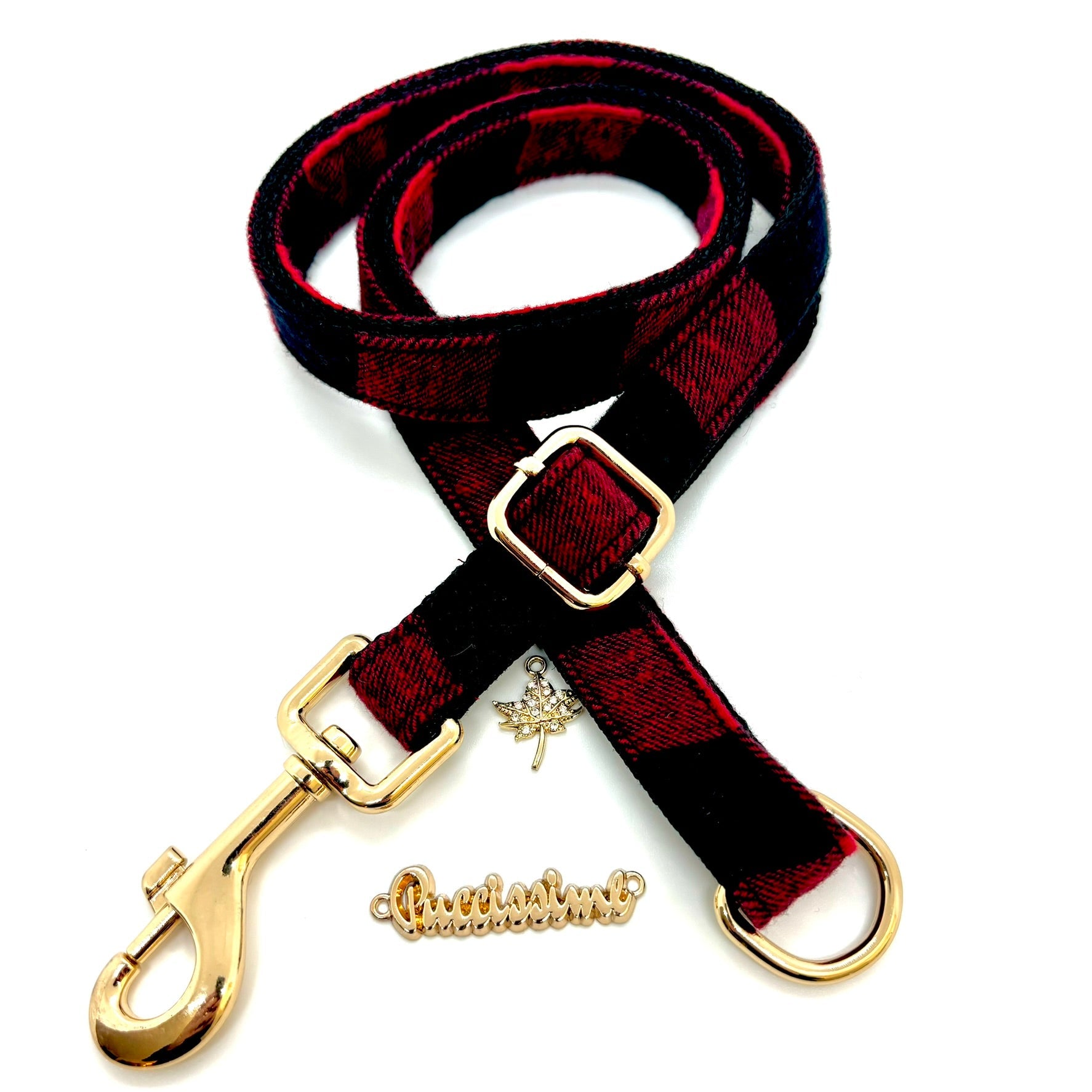 Red and black dog leash with gold hardware on a white background