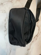 Black dog walk waist bag on a marble surface