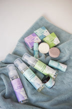 Pet Rince-Free Foaming pet products including bottles, boxes, and soaps on a blue towel