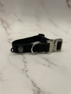 Black dog collar on a grey background