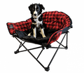 Dog sitting in a red and black checkered folding chair on a white background