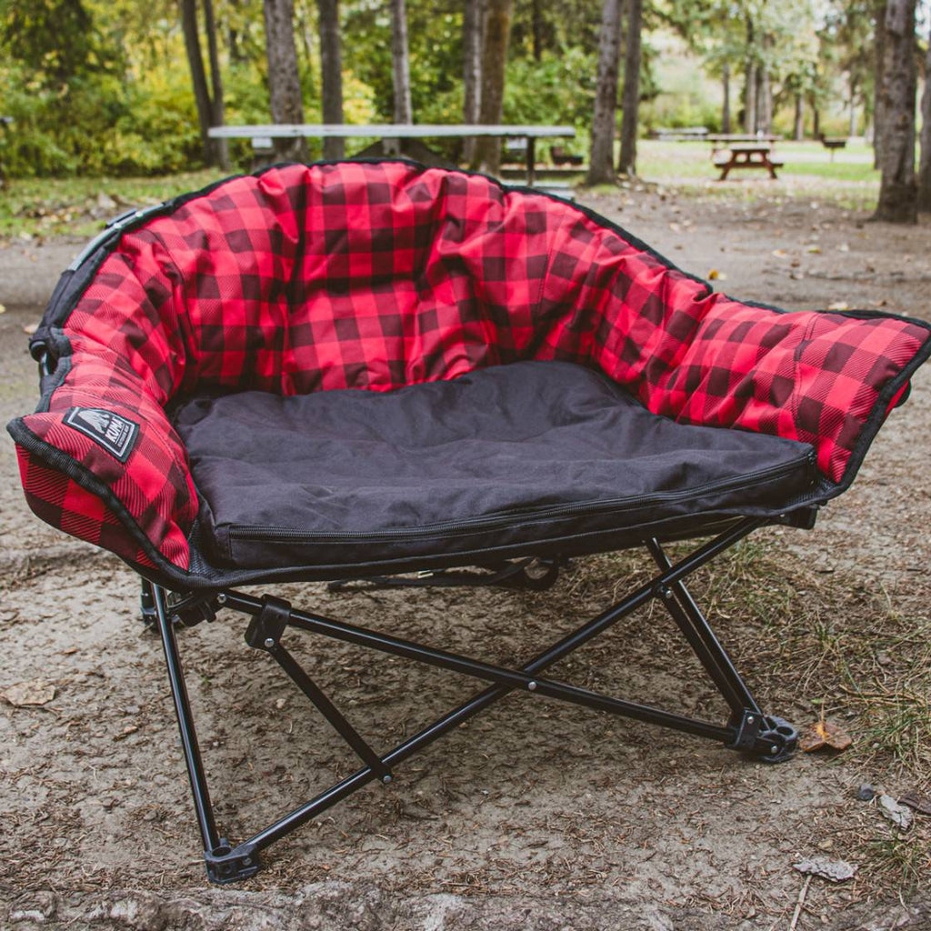 Red and black checkered camping chair in a park setting