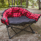 Red and black checkered camping chair in a park setting
