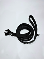Black dog leash with clip on a white background