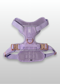 Lilac dog harness with gold hardware on a light gray background