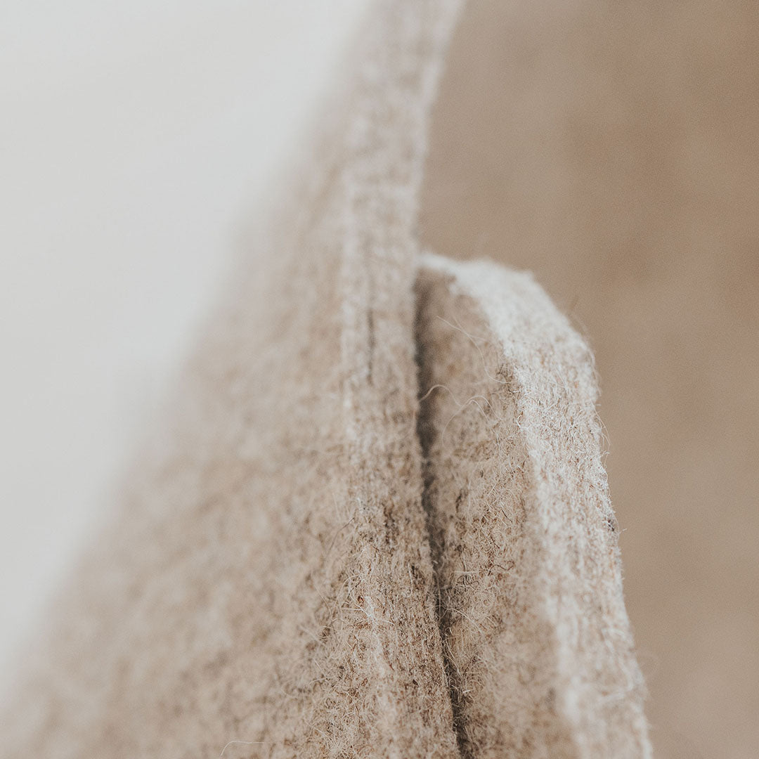 Close-up of a textured felt surface with a blurred background