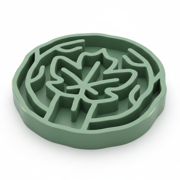 A mint green slow feeding bowl with maple leaf design, shown on a clean white background.