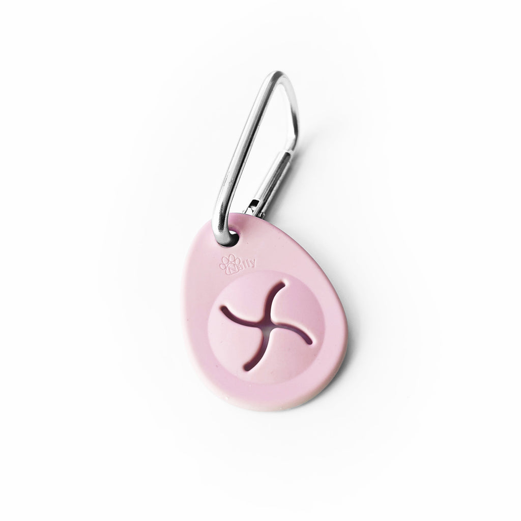 Pink oval-shaped poop bag holder on a white background