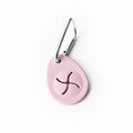 Pink oval-shaped poop bag holder on a white background
