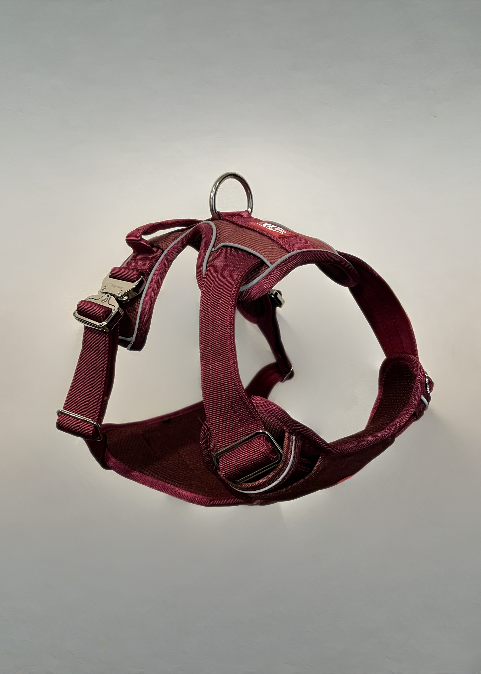 Red dog harness on a gray background