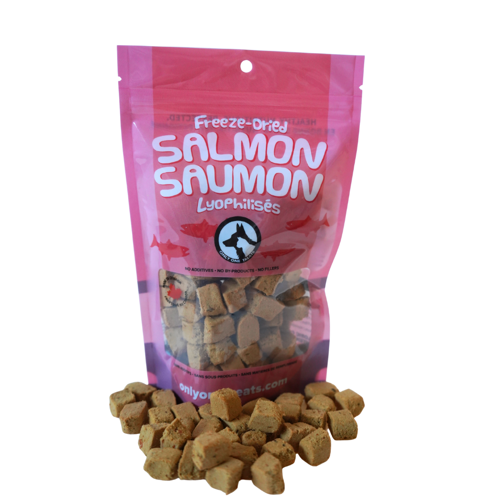 Pink package of freeze-dried salmon treats with visible treats on a white background