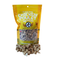 Bag of freeze-dried chicken poullets with product spilling out on a white background