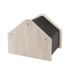 Wooden pet house with a black cushion on a white background