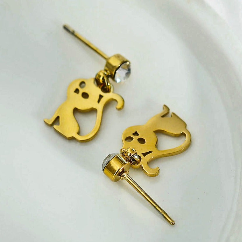Gold cat-shaped earrings on a white background