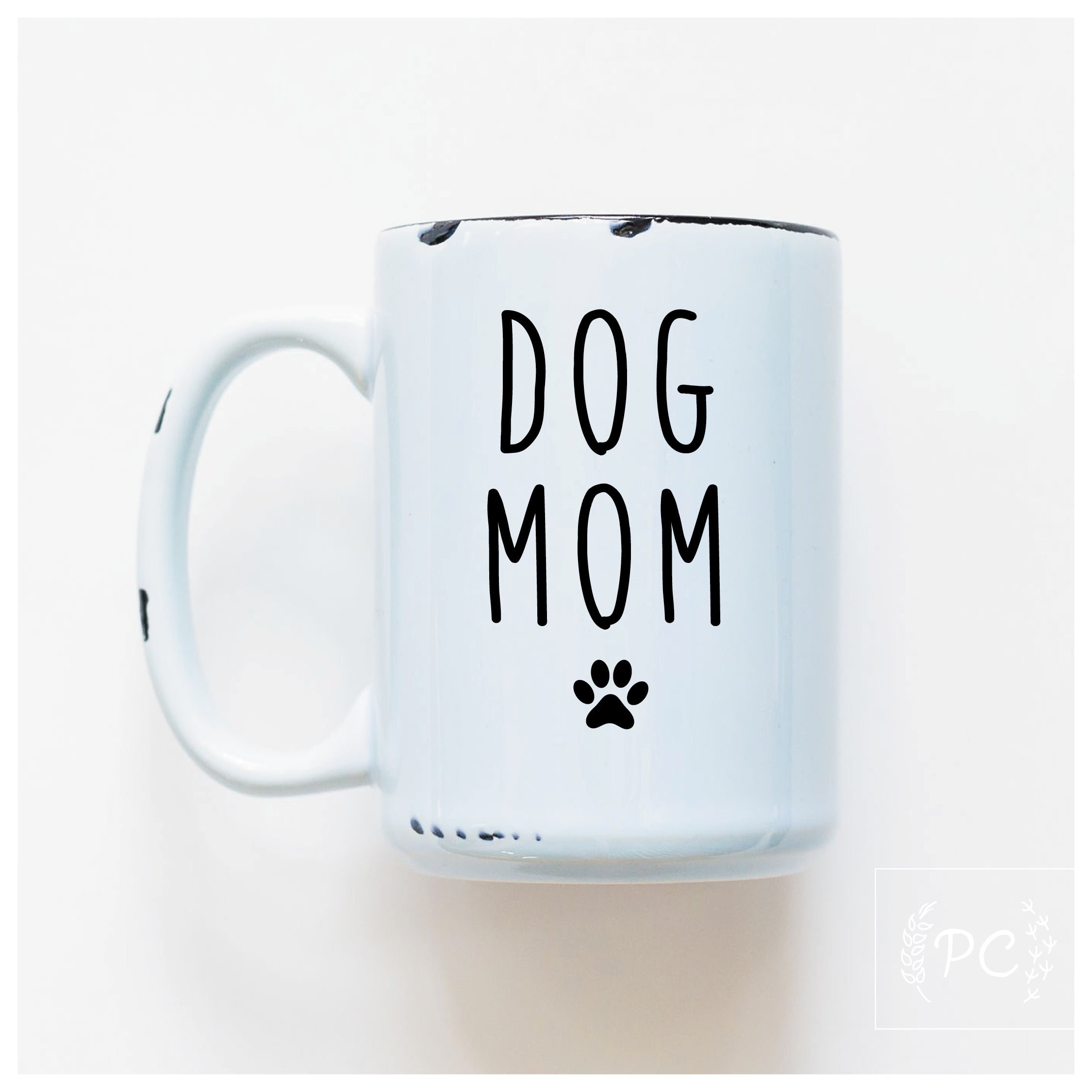 White mug with 'DOG MOM' text and paw print on a white background